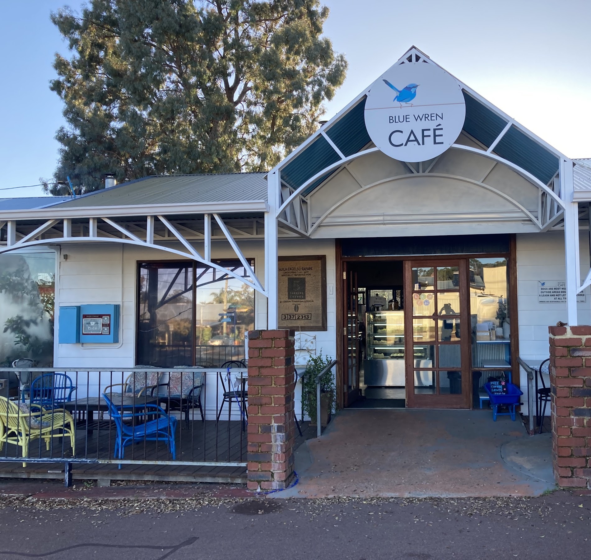 The front entrance of the cafe with the Blue Wren Cafe roundel sign above the door