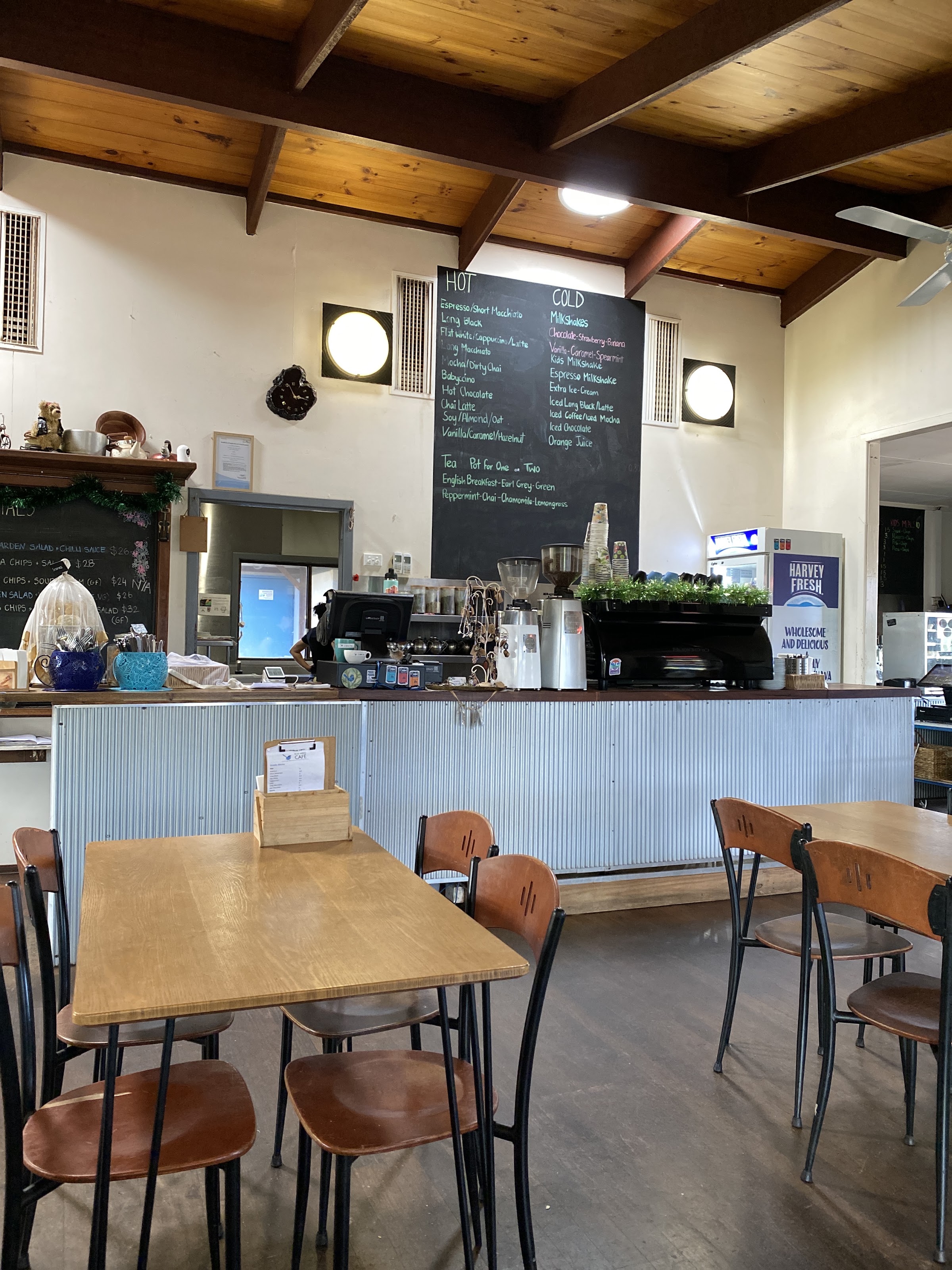 Inside the cafe: timber beams, the corrugated iron counter, the espresso machine and the hand written drinks board